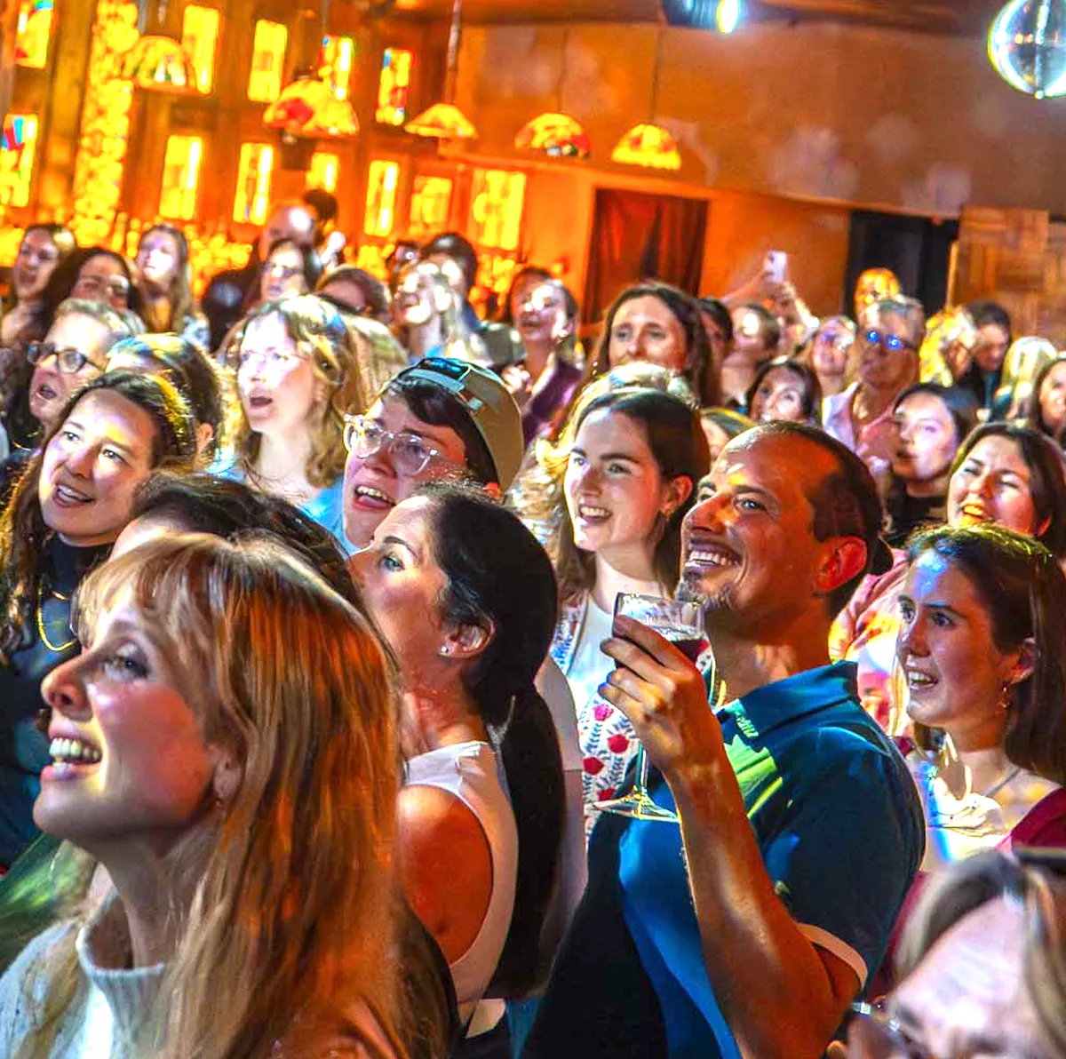 A crowd of happy faces mid-song